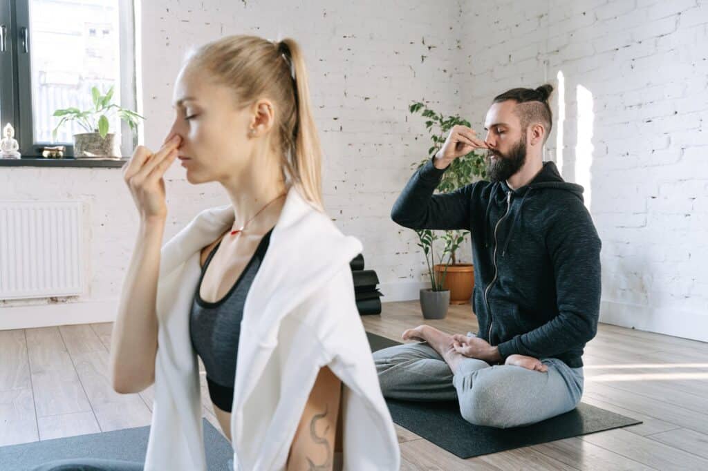 a man and a woman doing yoga; breathwork